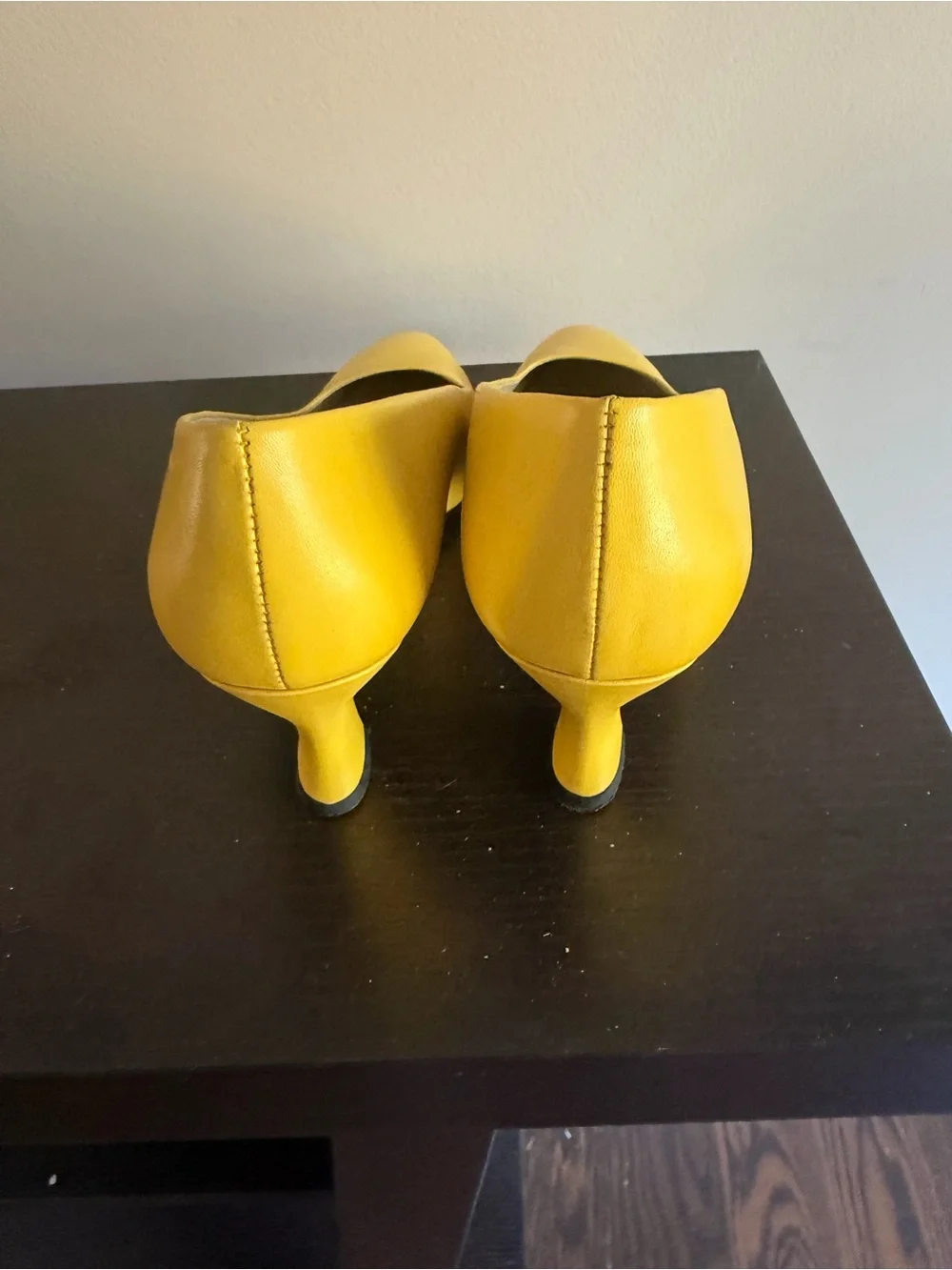 Nine West leather pointed-toe pumps featuring a distinctive flared kitten heel.